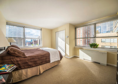 Furnished guest bedroom with natural light at Rittenhouse Claridge apartments