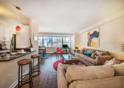 Furnished living room in open floor plan with Walnut Street views in Philadelphia, PA apartment