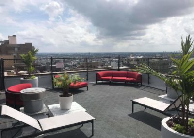 Spectacular Rittenhouse Claridge rooftop with comfortable lounging chairs and beautiful city view in Philadelphia, PA