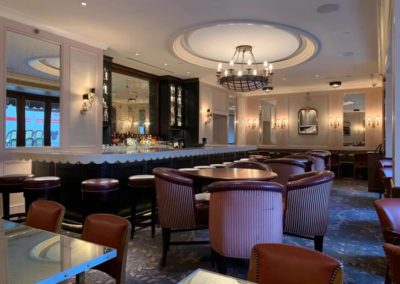 Phenomenal lounge room with extravagant bar, comfortable seating options and dangling chandelier at Rittenhouse Claridge